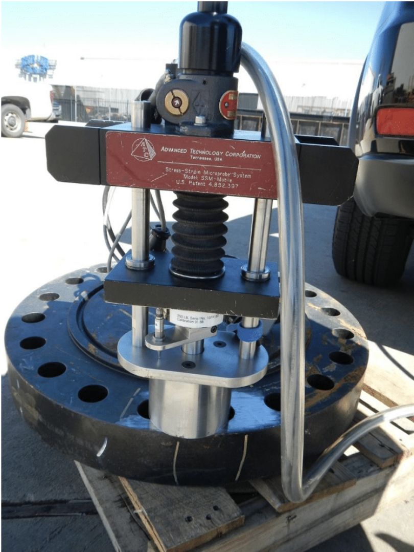 Figure 1: SSM®-Mobile system testing a steel flange in a yard. The load frame is temporarily mounted on the steel flange using a custom-made small-cylindrical DC magnet.